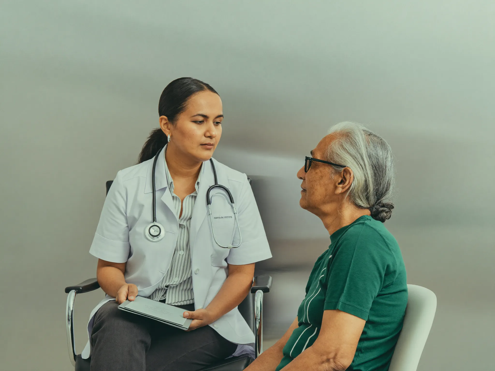 A doctor listening to a patient in a softly lit chamber
