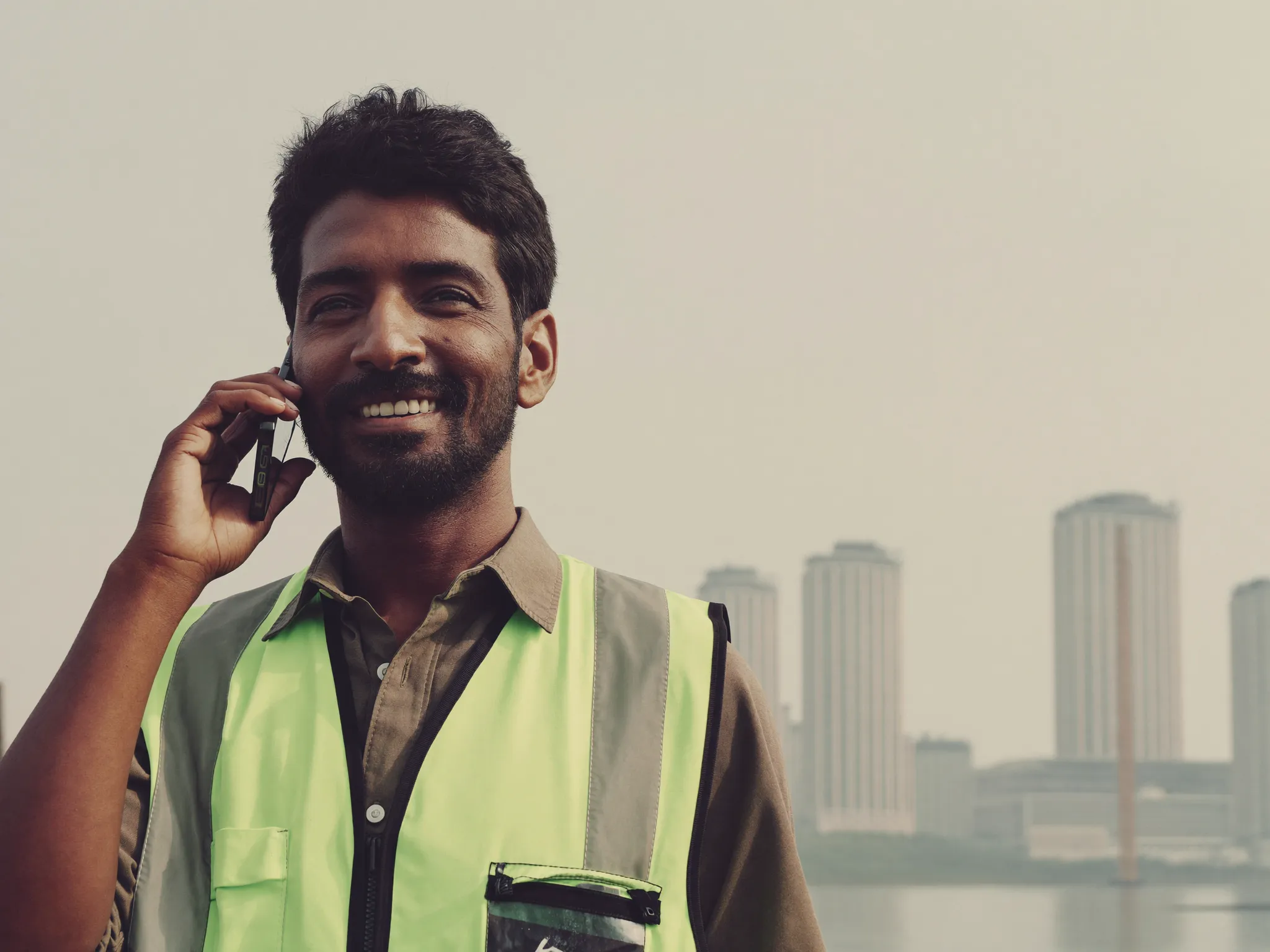 A migrant worker holding a phone